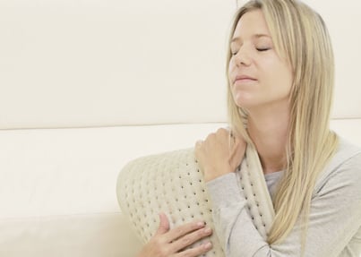 Woman using heat pad