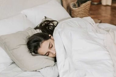 Woman-Sleeping-on-a-Bed-With-White-Blanket-