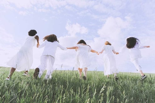 Women-in-White-Dress-Running-on-Green-Grass-Field-